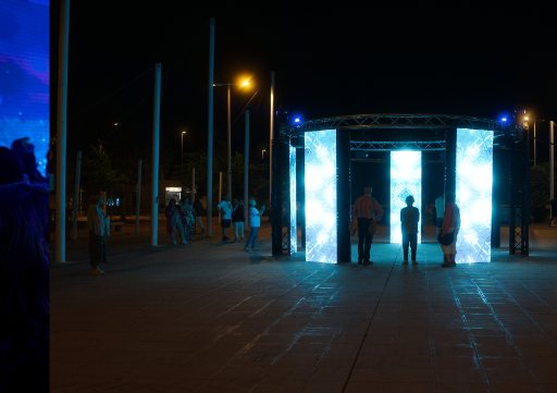 Blue vertical light structures forming an installation in darkness