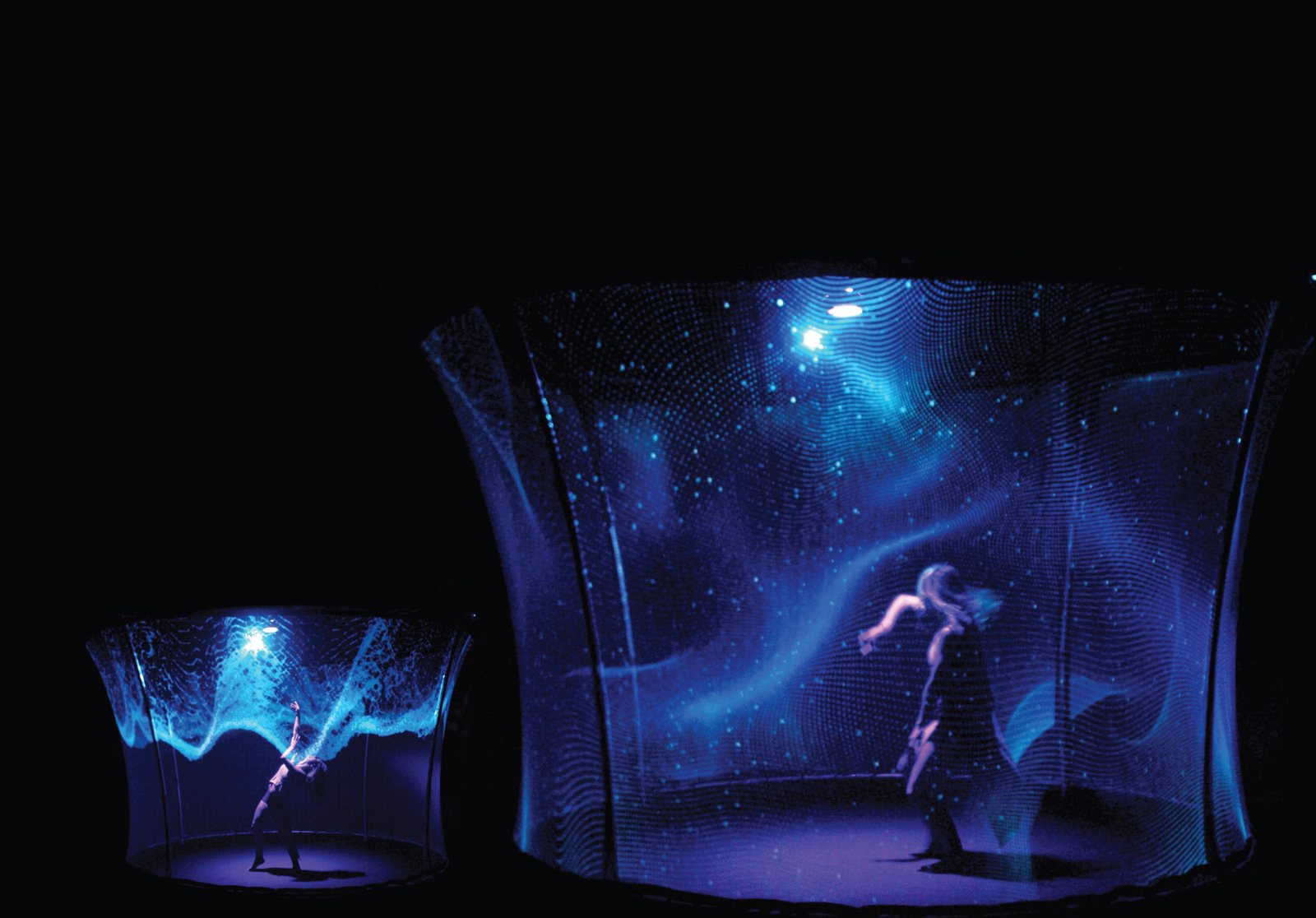 Immersive stage composition with a performer and projected geometry